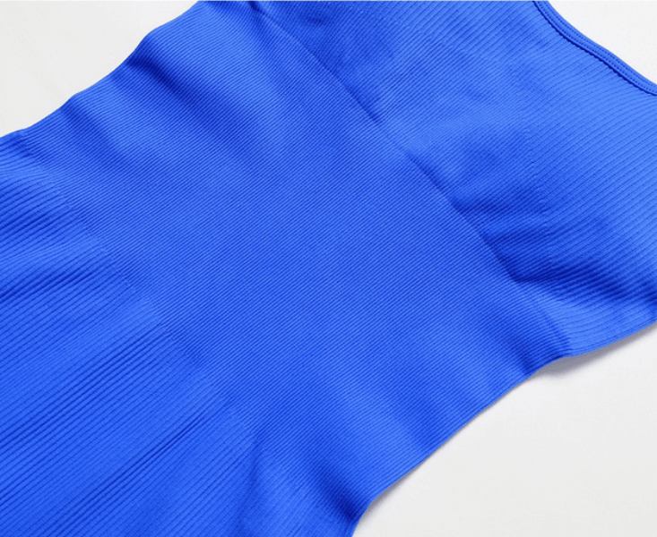 Close-up of blue seamless one piece short yoga suit fabric for women, showing breathable, stretchy nylon and spandex material.